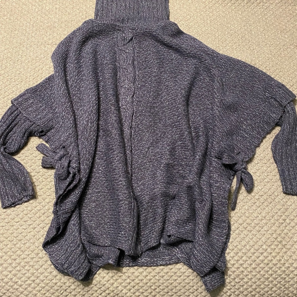 Turtleneck sweater with ties on the side